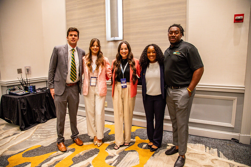 Five college students stand together before competing in the 2025 Collegiate Discussion Meet competition.