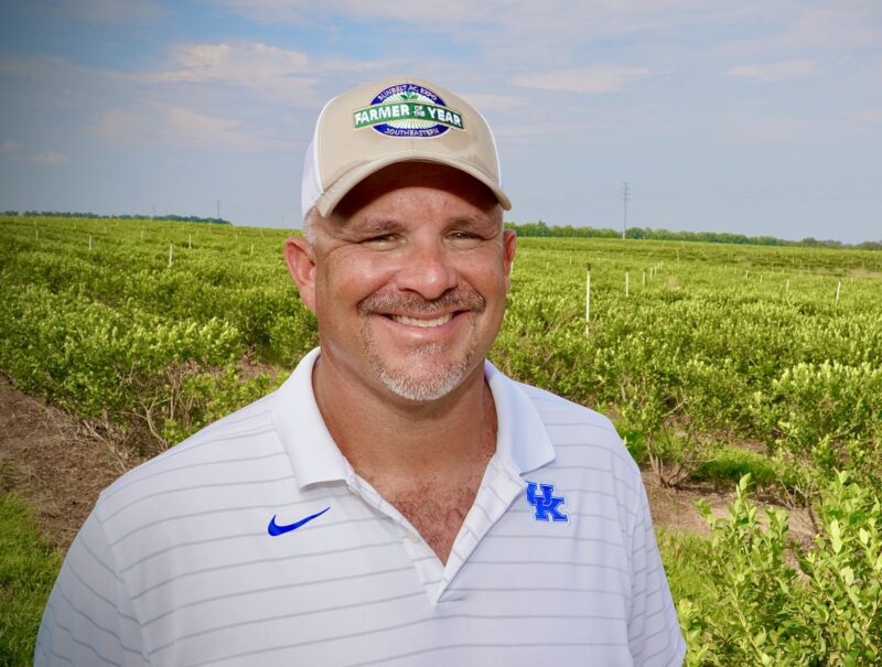 Jason Watts, 2024 Florida Farmer of the Year, standing in a cultivated crop field