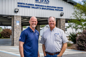FFBF President Jeb S. Smith and Bob Hochmuth stand outdoors in front of the UF/IFAS North Florida Research and Education Center.
